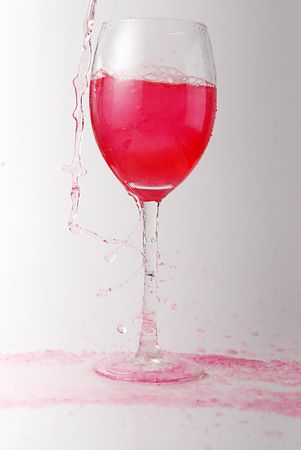 pour red wine into glassの写真素材