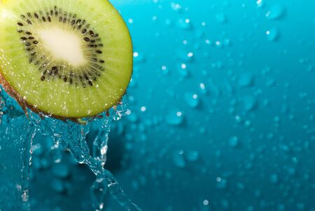 water drops on slice of kiwiの写真素材