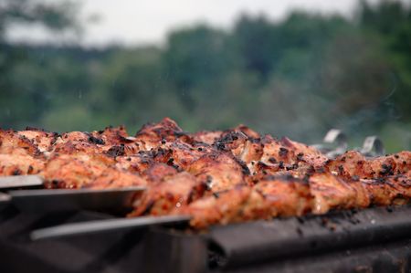 Preparation of meat slices in sauce on fireの写真素材