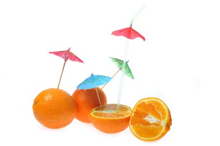 oranges with coctail umbrellas isolated on whiteの写真素材