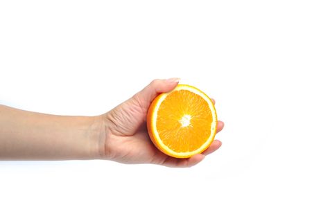 woman holding ornage close upの写真素材