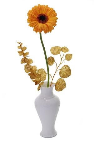 orange flower with golden leaves in vase isolated on whiteの写真素材