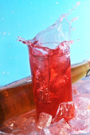 bottle with drink and  glass with ice  on  surfaceの写真素材