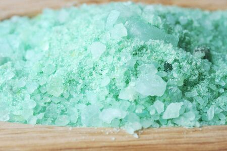 Green sea salt for bathing  on  wooden tray  close up の写真素材