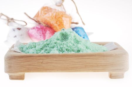 Pink, white,  blue, green and orange salt for  bath on  white backgroundの写真素材