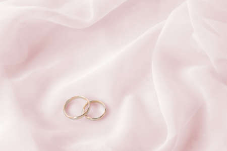 White transparent  fabric and wedding rings close upの写真素材