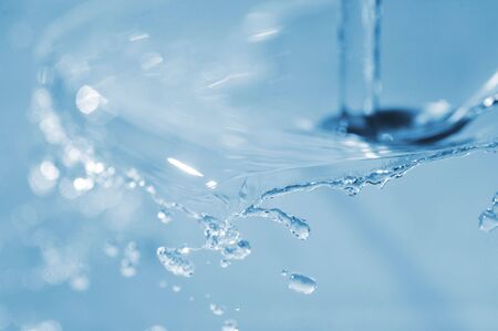 transparent splashes and water drops on  violet close upの写真素材