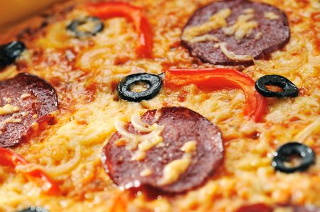 Close up of  pizza with tomatoes, cheese, black olives and  peppersの写真素材