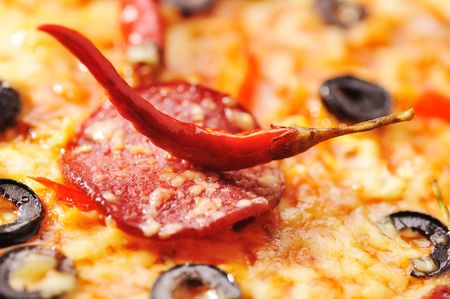 Close up of  pizza with tomatoes, cheese, black olives and  peppersの写真素材