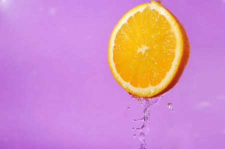 bright juicy orange and splashes on  violet background