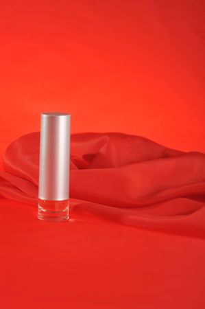 Bottle of perfume, isolated on red close upの写真素材