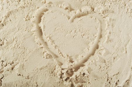 heart drawn in the smooth sandの写真素材
