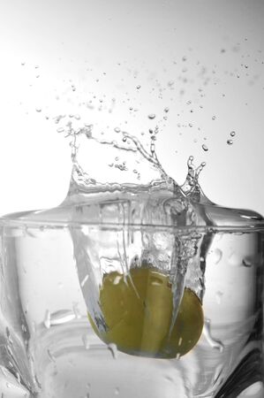 Cold transparent water in  glass and splashesの写真素材