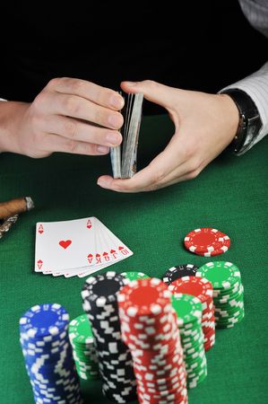 man  sitting at the gambing table and  playing cards