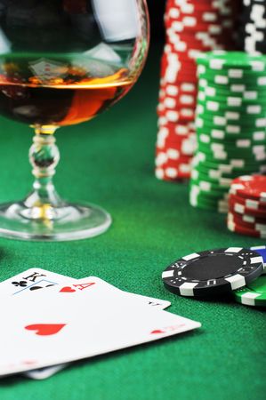  color chips for gamblings, drink and playing cards on green