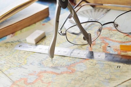  opened old atlas book on  map and  glasses