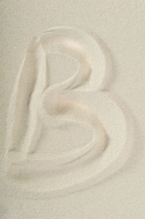 letter written on sea sand close upの写真素材