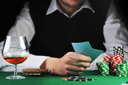 man  sitting at the gambing table and  playing cardsのeditorial素材