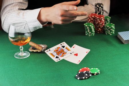 man  sitting at the gambing table and  playing cardsのeditorial素材
