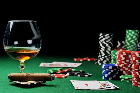 Cigar, chips for gamblings, drink and playing cards on greenのeditorial素材