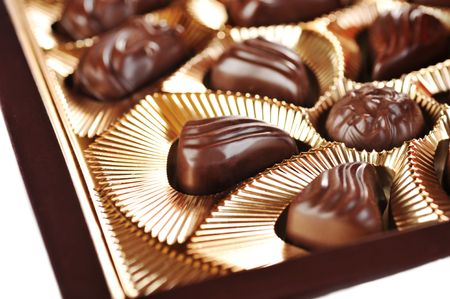 Gold foil box of assorted chocolates background の写真素材