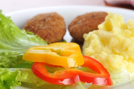 roasted cutlets of pork with potato and  lettuceの写真素材