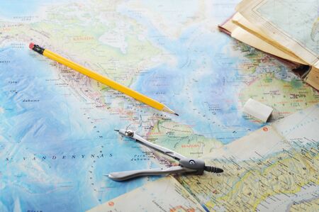  opened old atlas book on  map and pensilの写真素材