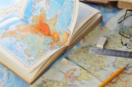 
 opened old atlas book on  map and  glassesの写真素材