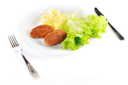 roasted cutlets of pork with potato and  lettuceの写真素材
