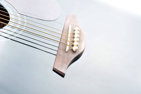 Detail of an acoustic black guitar with the strings の写真素材