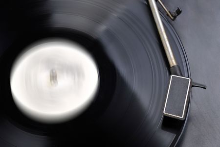 Vinyl record spinning on turntable close up