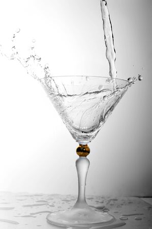 pouring liquid into cocktail glassの写真素材