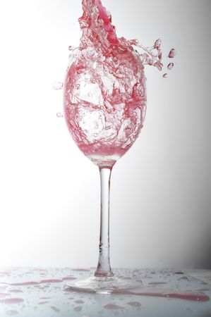 pouring liquid into  wineglassの写真素材