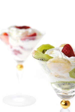  fresh chopped strawberries, kiwi and banana with whipped cream in glasswaresの写真素材