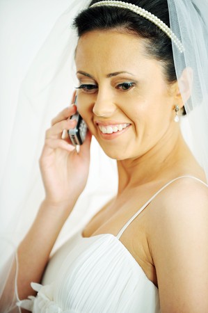  beautiful stylish bride speaks on  phone. Studio portraitの写真素材