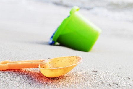 small children bucket and scoop on sea shoreの写真素材