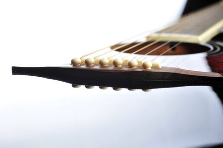 Detail of an acoustic black guitar with the strings and the sound hole