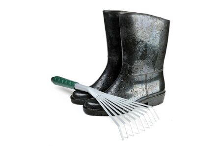 Gardening tools: rubber boots and rake の写真素材