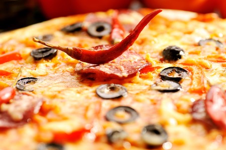 Close up of  pizza with tomatoes, cheese, black olives and  pepperの写真素材