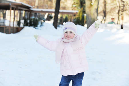 small beautiful girl playing in park.  winter dayの写真素材