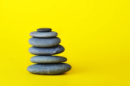 stone tower isolated on yellow backgroundの写真素材