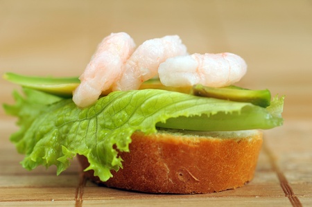 Sandwich garnish with shrimps, avokado and lettuce on  bamboo napkin, snackの写真素材