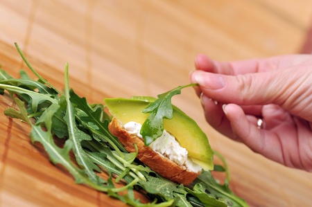 delicious sandwich of toasted bread, avocado and spinachの写真素材