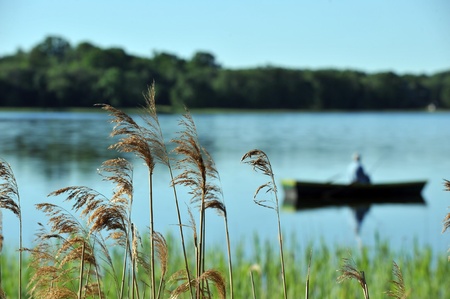 fisherman in  boat in summer day. fishing on  lakeの写真素材