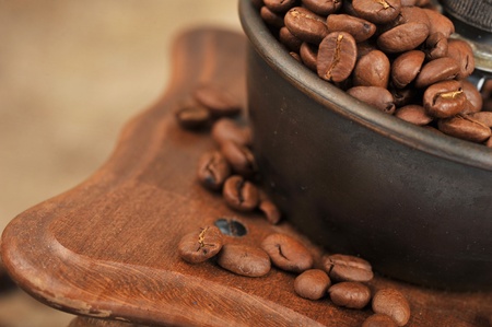 Vintage manual coffee grinder with coffee beans isolatedの写真素材