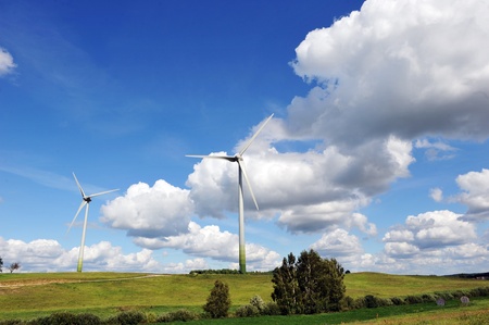 wind turbines in the fields under blue sky