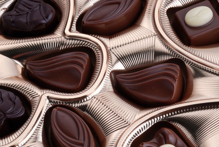 Gold foil box of assorted chocolates background