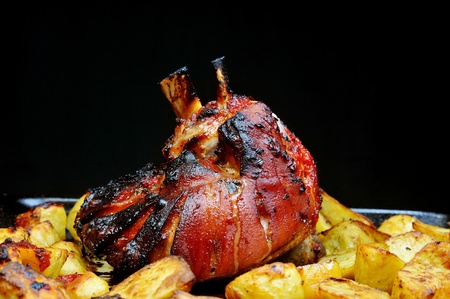 Delicious  pork shanks with fried potatoes, cooked in  ovenの写真素材
