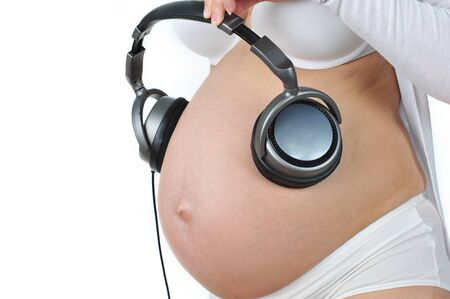 Pregnant woman with headphones on her stomach. Future baby listens to music.
の写真素材