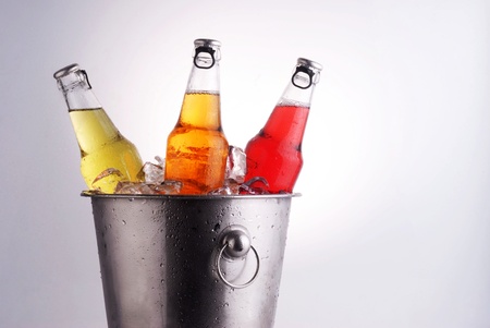  three different beer bottles in bucket of ice with condensationの写真素材